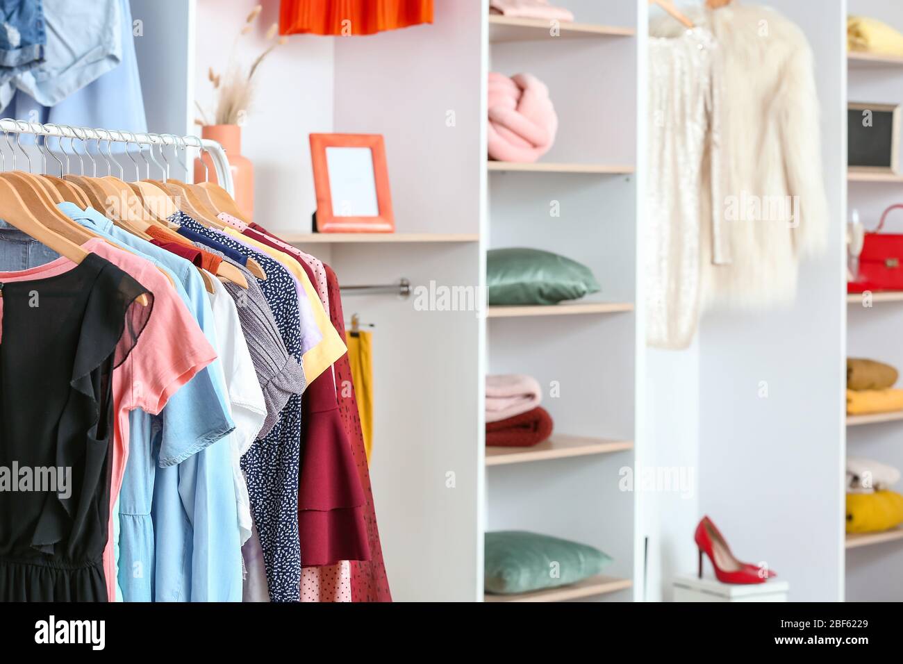 Stylish clothes on hangers in modern store Stock Photo - Alamy