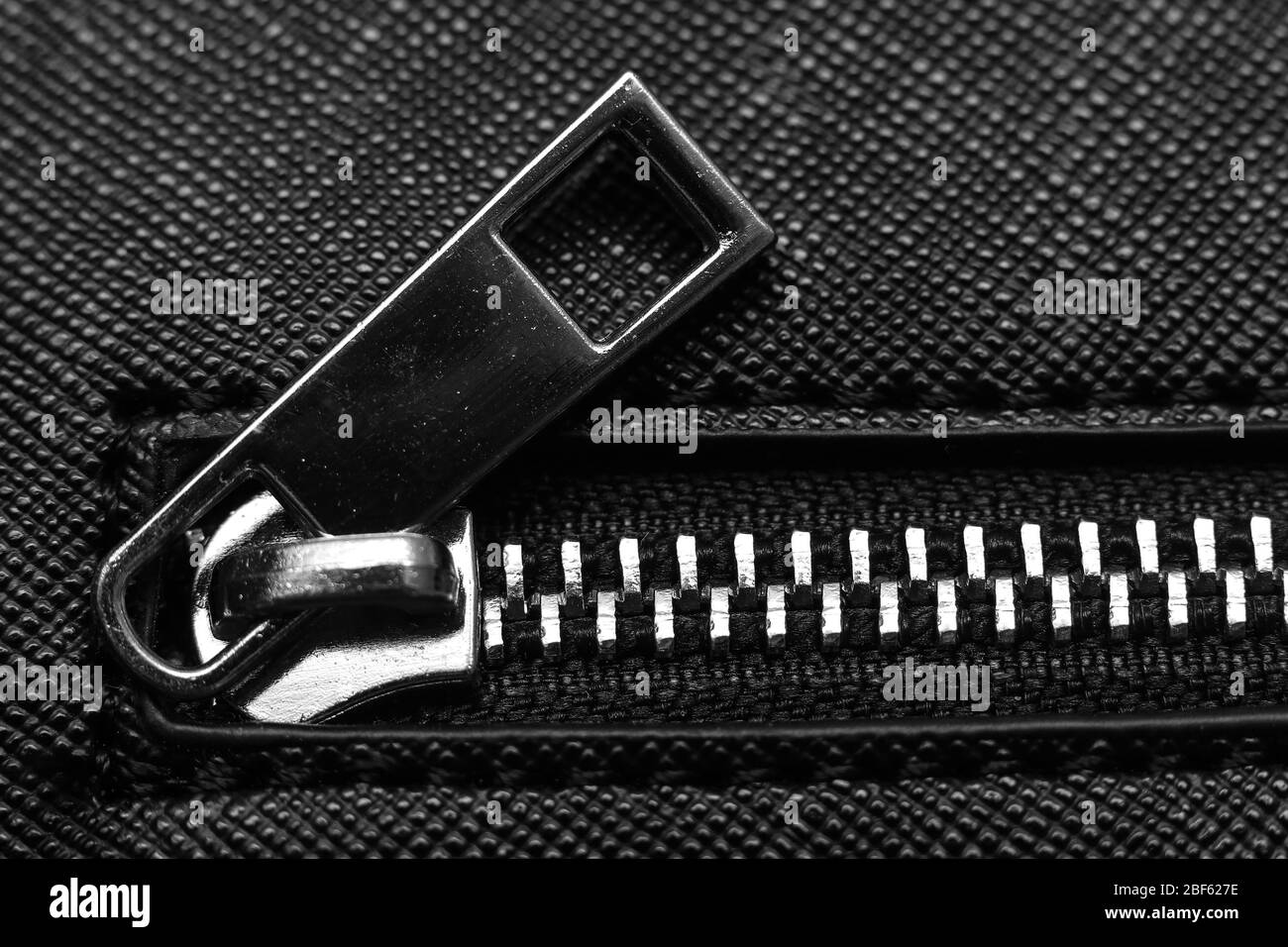 Close up of zip fastener on black women's handbag Stock Photo