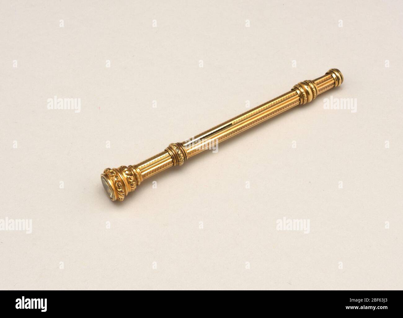 pencil. Gold cylinder, moulded and engraved, with imitation gem in head
