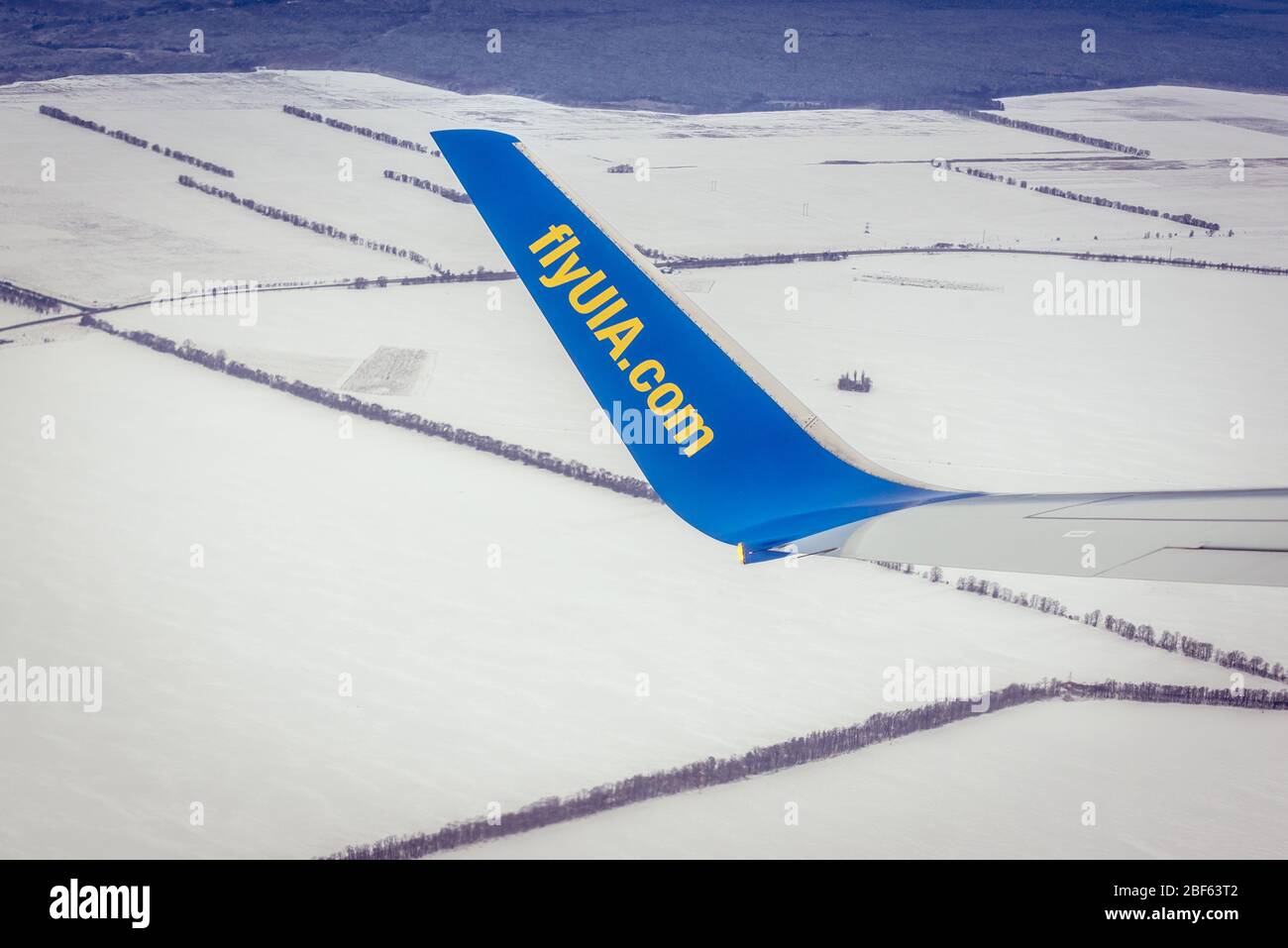 Wing of plane of Ukraine International Airlines after takeoff from Boryspil International Airport in Boryspil near Kiev city, Ukraine Stock Photo