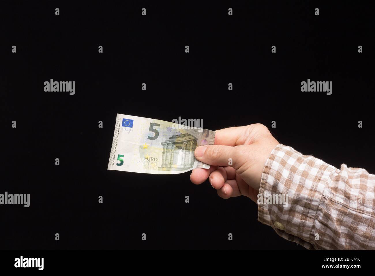 Wad of euro banknotes in the hand of a person, prepared to buy or to save and enter the bank. Banknotes of legal tender, European currency. Stock Photo