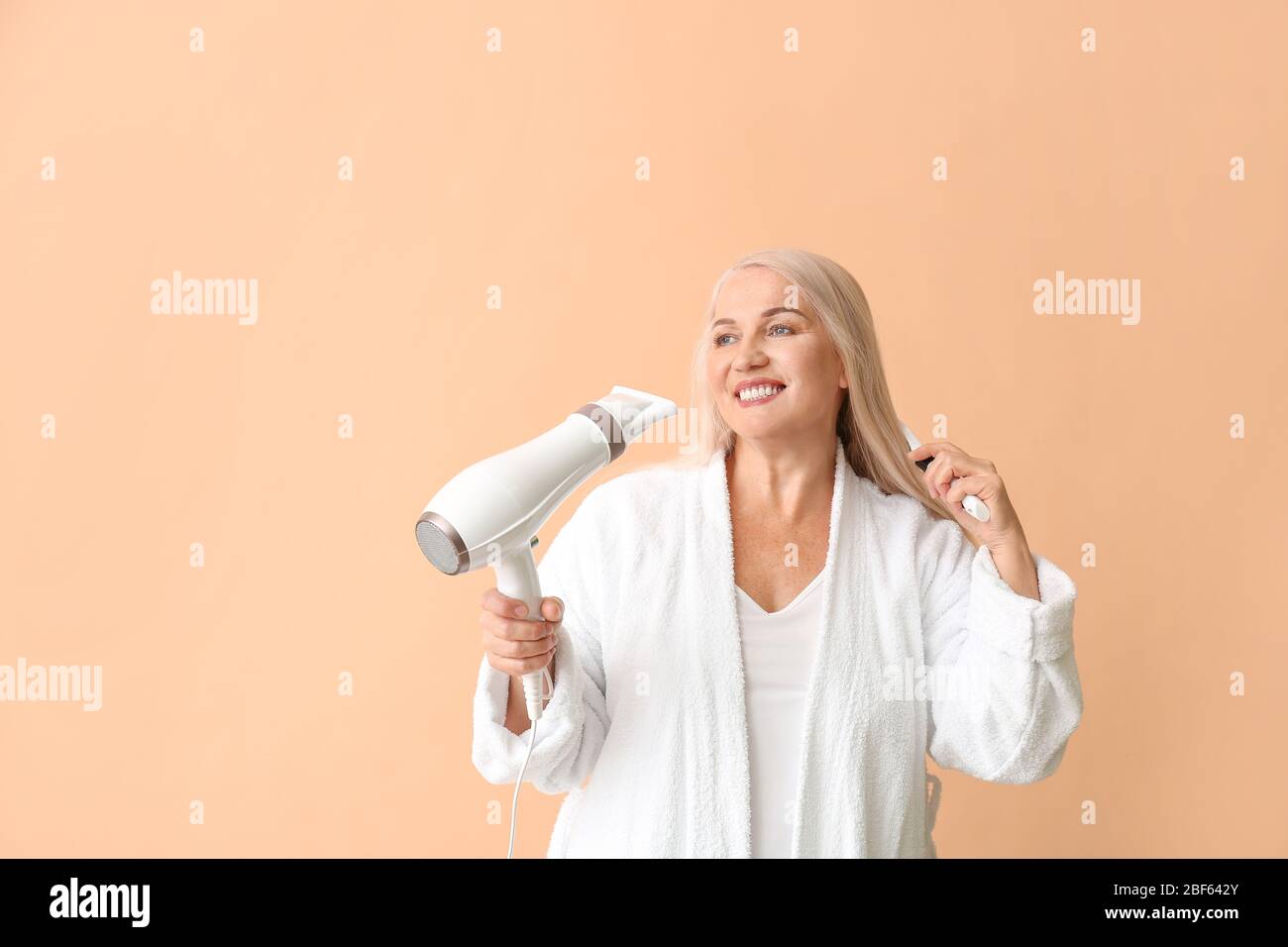 Mature woman hair brush dryer hi-res stock photography and images - Alamy