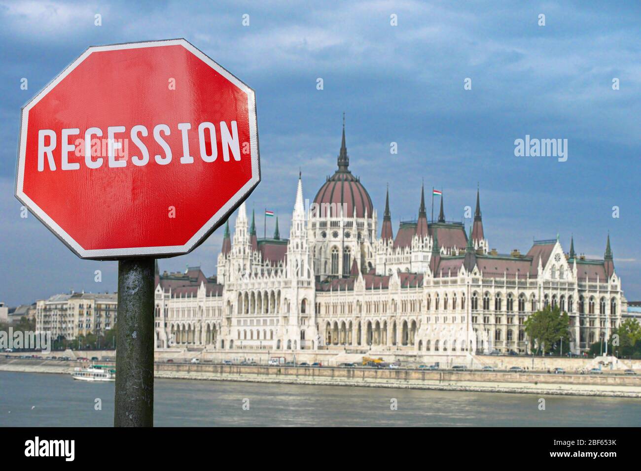 Recession stop sign with view of parliament in Budapest, Hungary. Financial crash in world economy because of coronavirus pandemic. Stock Photo