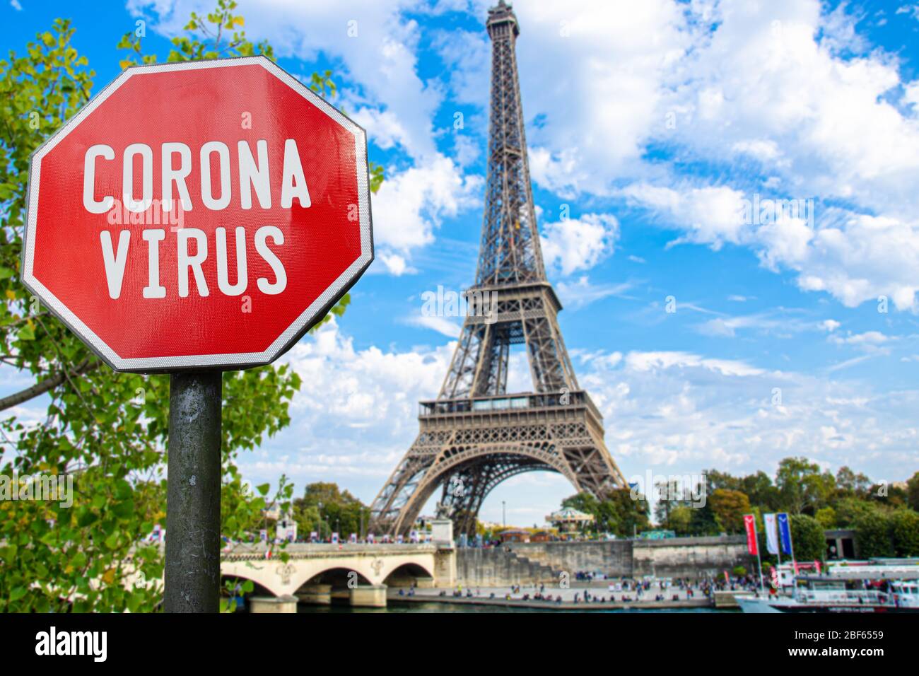 Corona virus sign with Eiffel tower in Paris, France. Warning about pandemic in France. Coronavirus disease. COVID-2019 alert sign Stock Photo