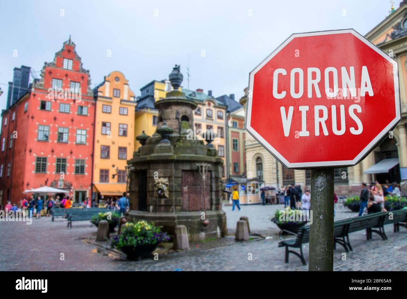 Corona virus stop sign with view of historic old town in Stockholm, Sweden. Warning about epidemic quarantine. Coronavirus disease pandemic. COVID-201 Stock Photo