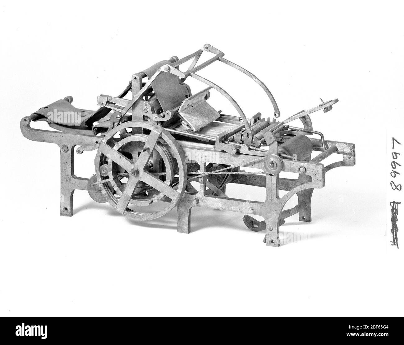 Patent Model for a Chromolithographic Press. This patent model demonstrates an invention for a chromolithographic press which was granted patent number 89997. The patent details a flatbed scraper machine with automatic inking, damping, feeding, and delivery. Stock Photo