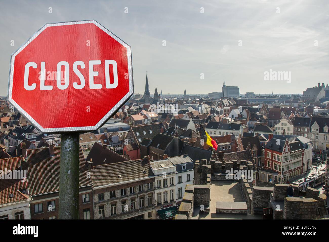 Closed, close stop sign with Brussels view, Belgium. Closed facilities because of corona virus. COVID-19 pandemic quarantine. Stock Photo