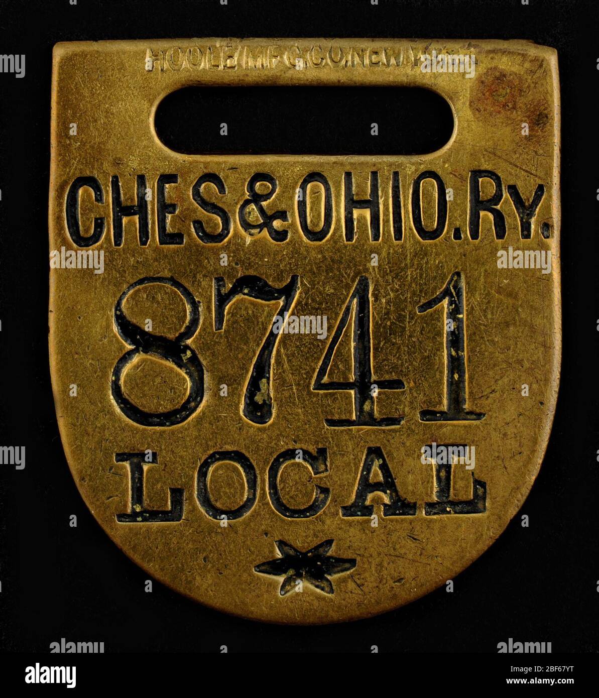 Chesapeake Ohio Railway Owney tag. Owney received this baggage check token while traveling along the Chesapeake & Ohio Railway. The “local” marking indicates that the tag was meant for use on the main line, not for someone traveling onto another railway line. Stock Photo