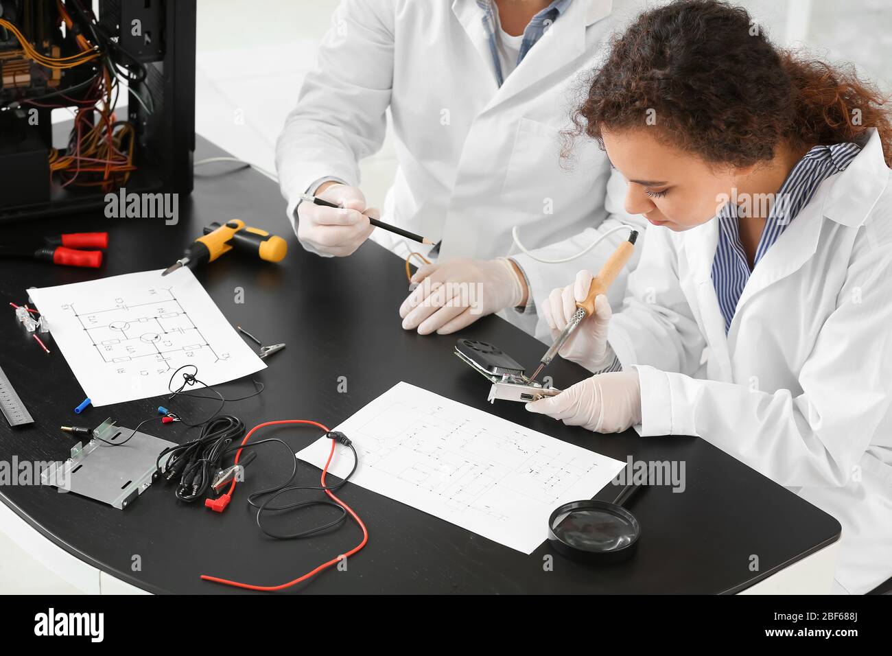 Electronic technicians working in service center Stock Photo