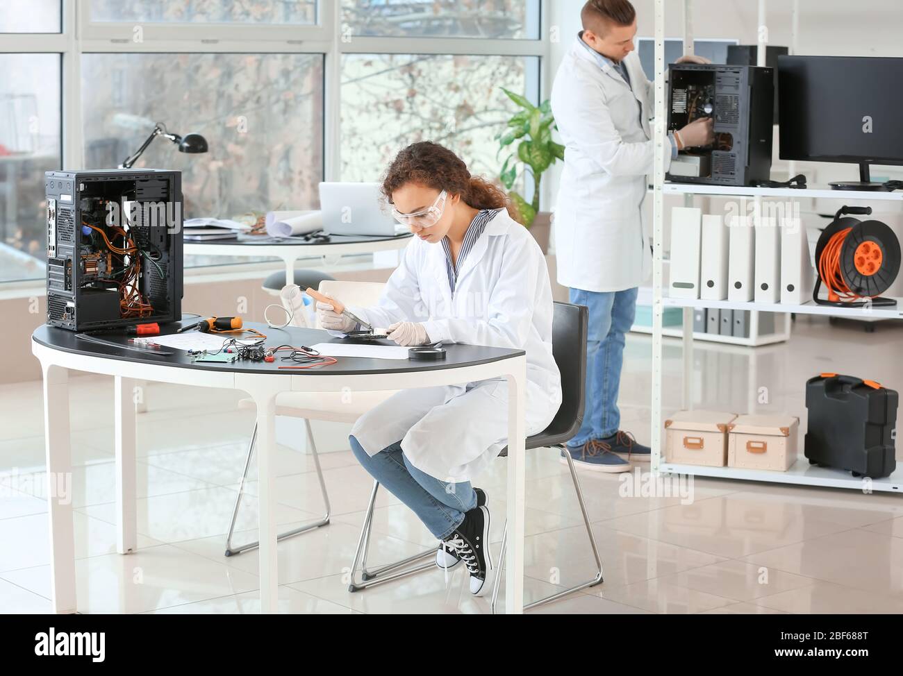 Electronic technicians working in service center Stock Photo