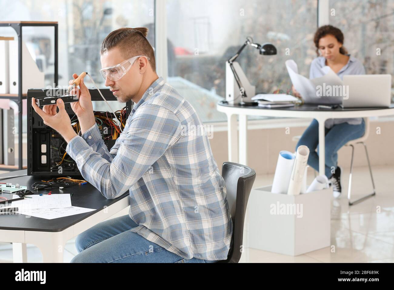 Electronic technician working in service center Stock Photo
