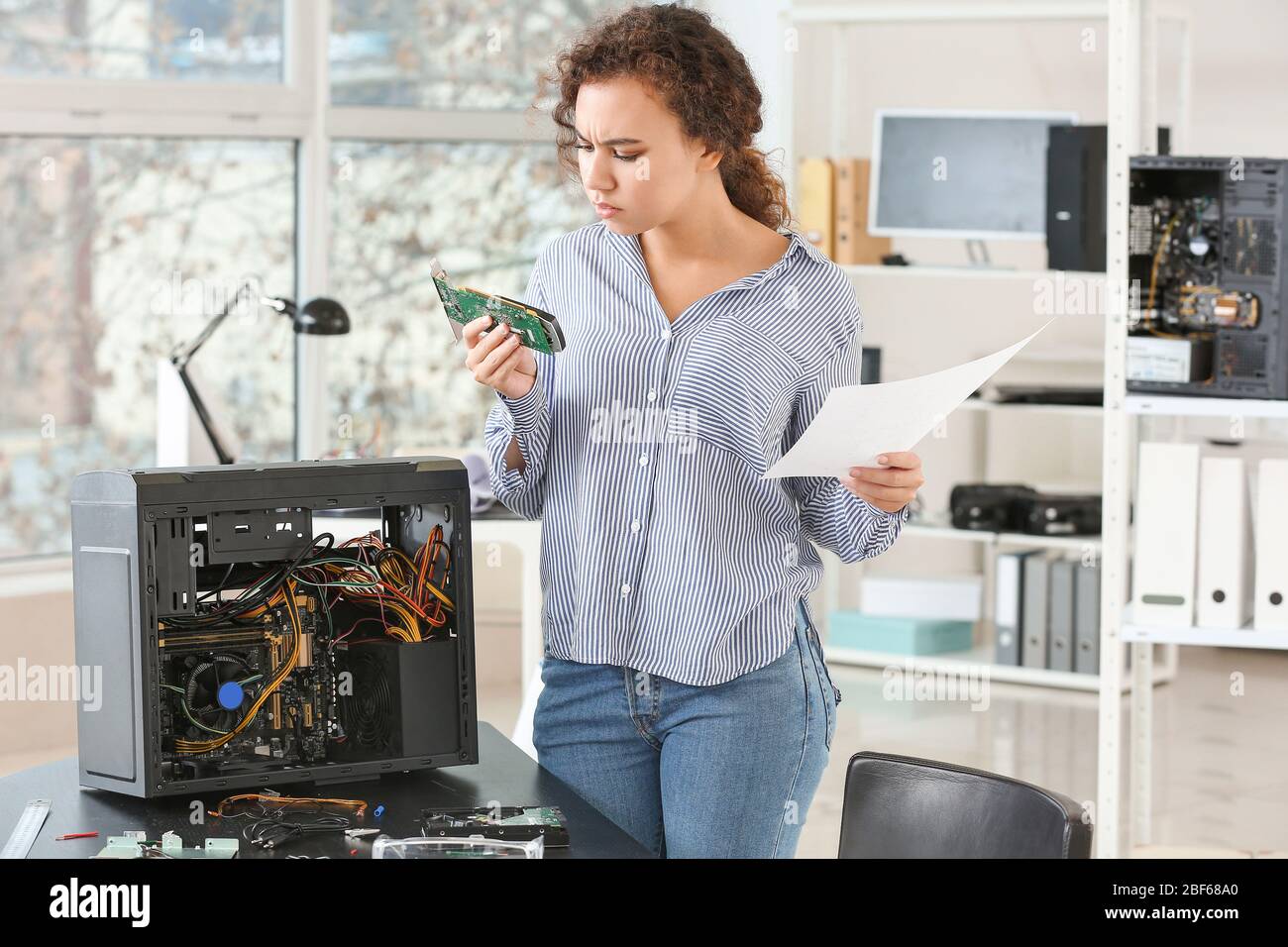 Electronic technician working in service center Stock Photo