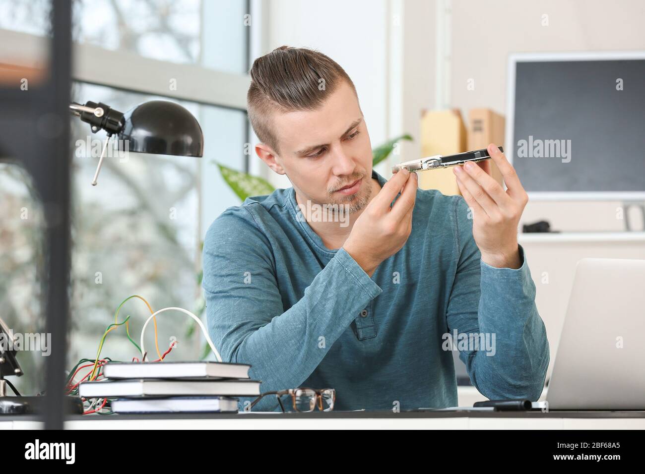 Electronic technician working in service center Stock Photo
