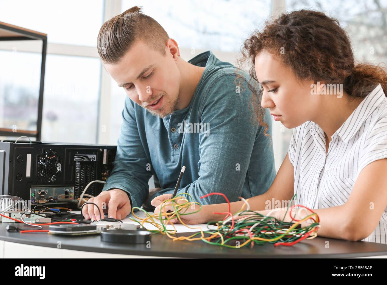 Electronic technicians working in service center Stock Photo Alamy