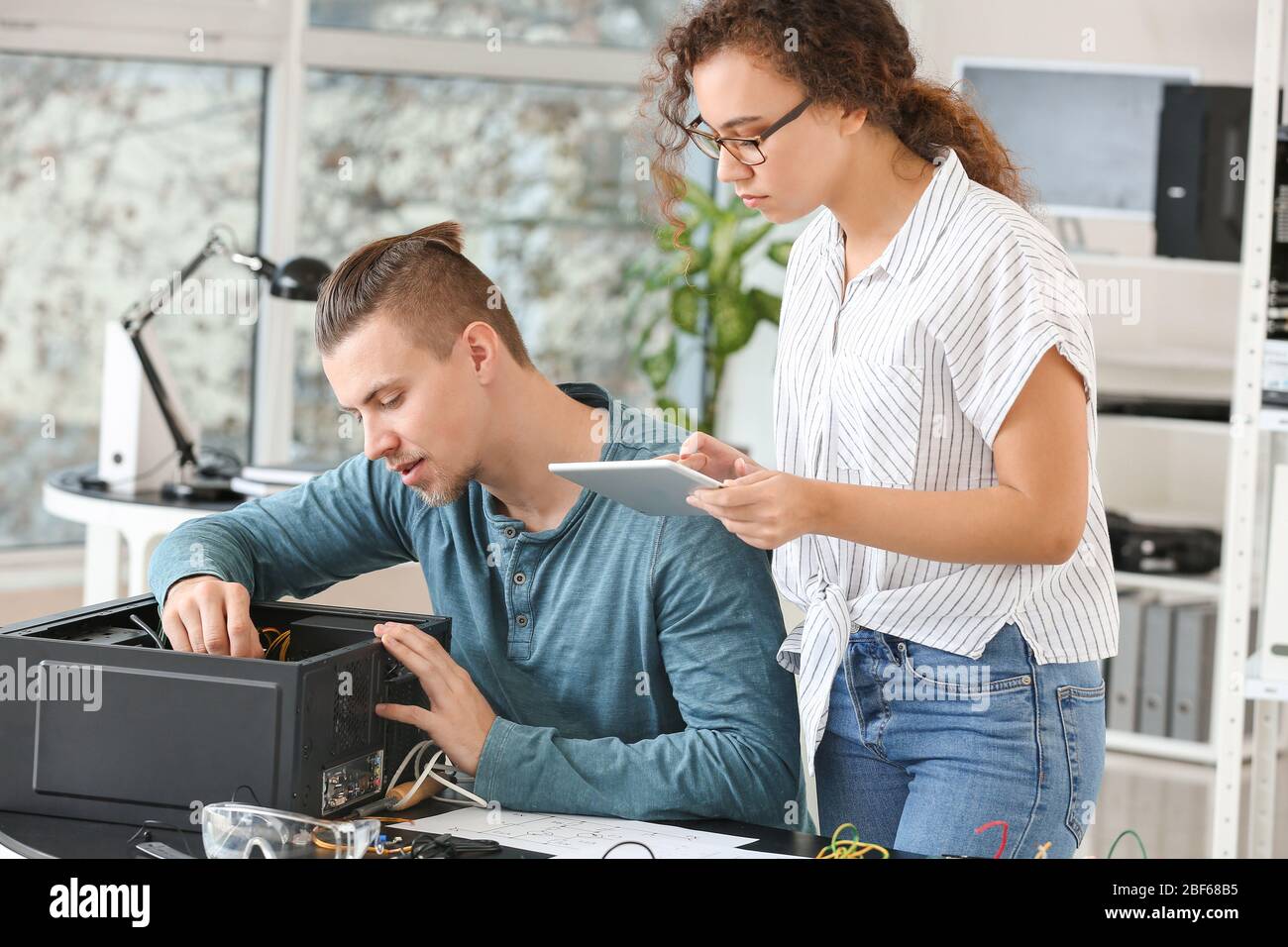 Electronic technicians working in service center Stock Photo