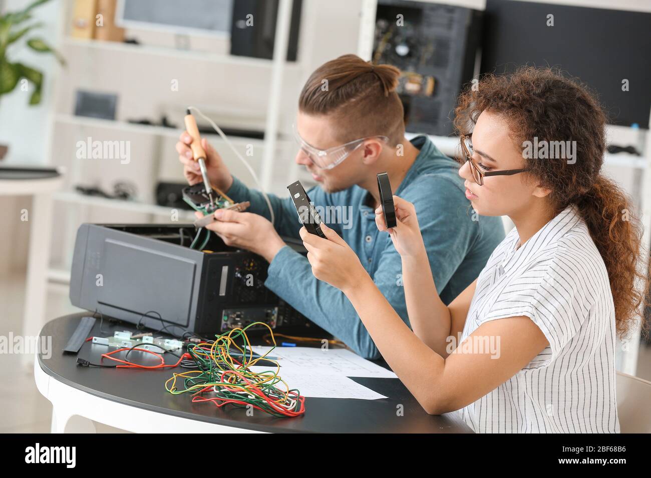 Electronic technicians working in service center Stock Photo