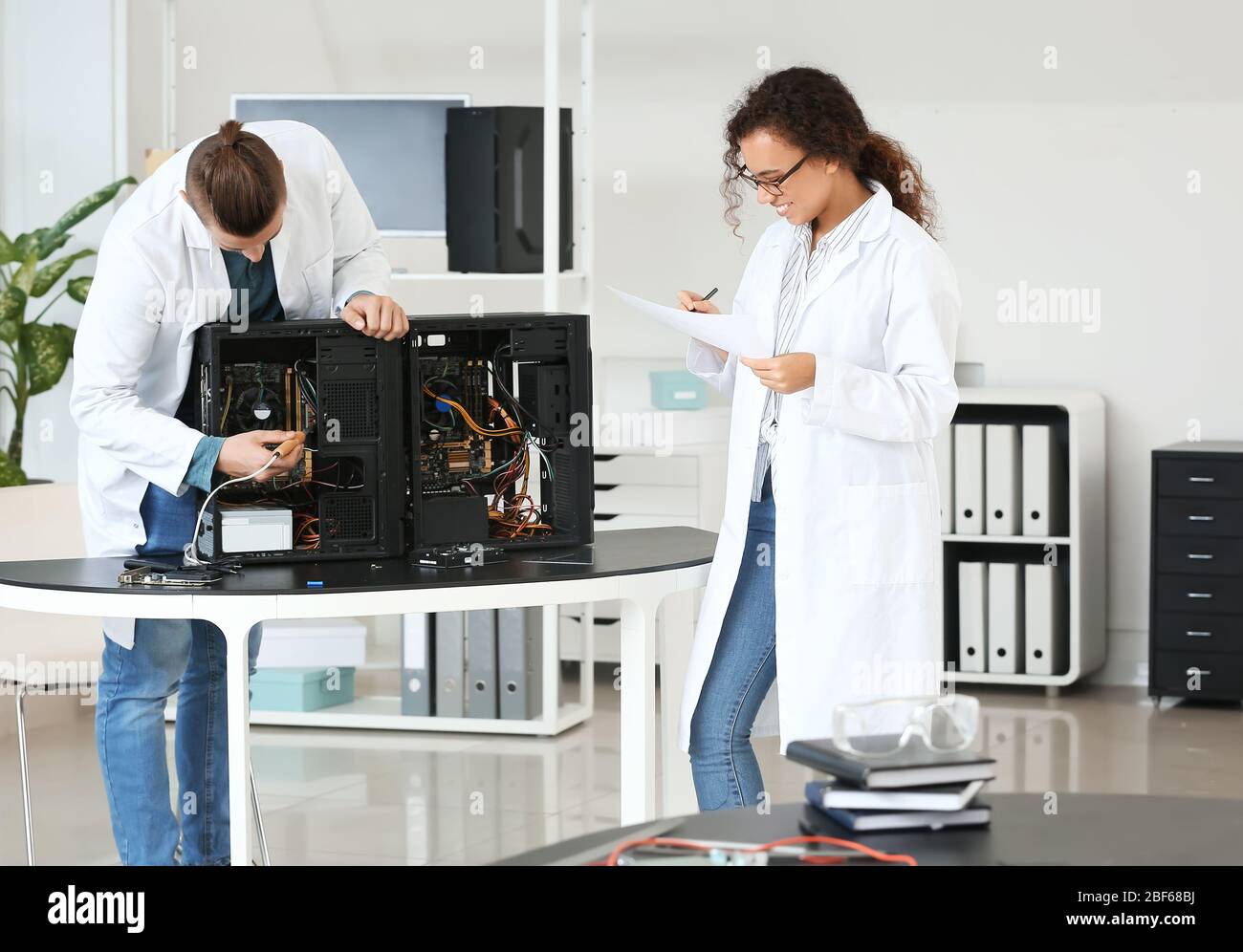 Electronic technicians working in service center Stock Photo