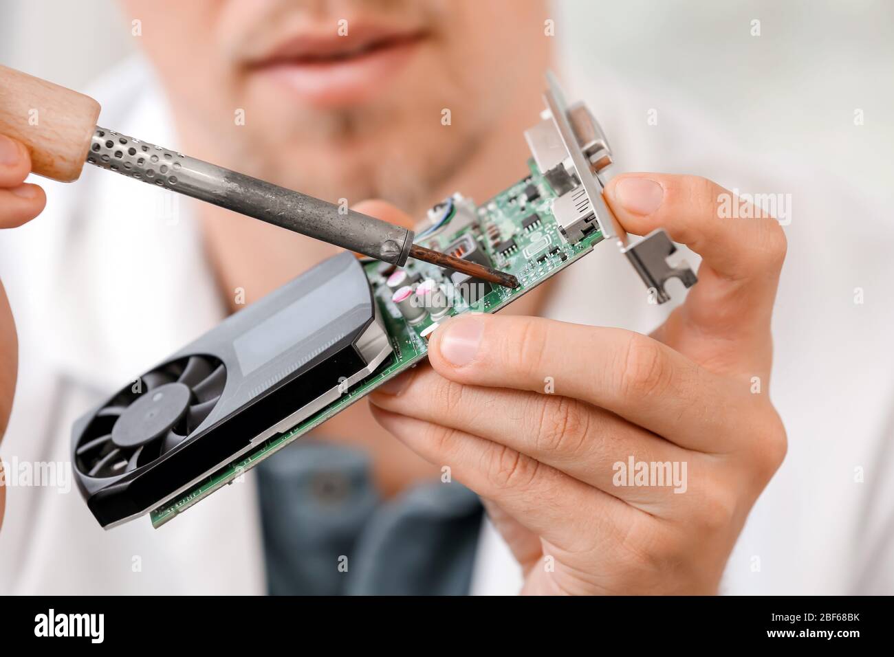 Electronic technician working in service center Stock Photo
