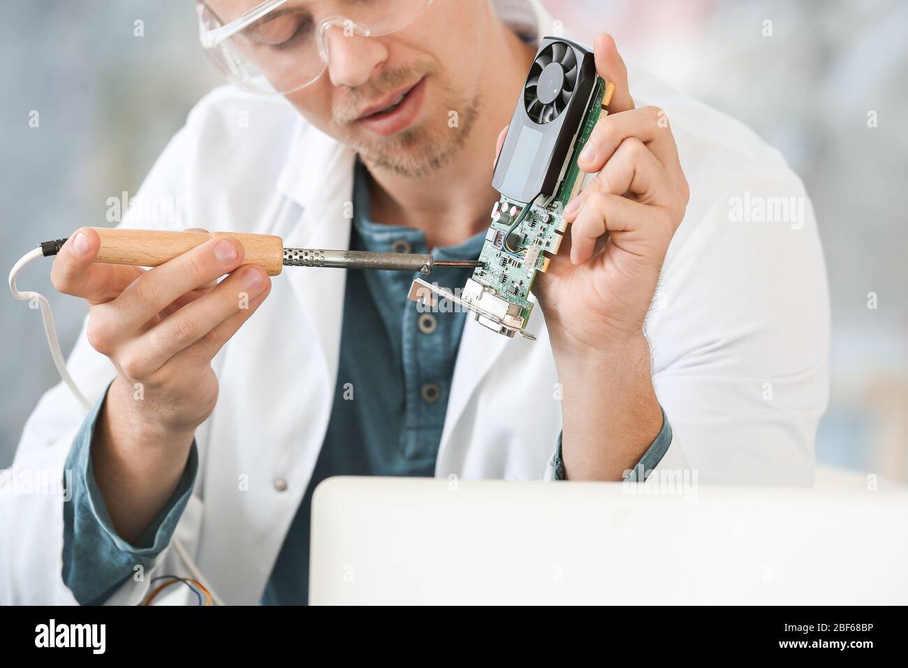 Electronic technician working in service center Stock Photo