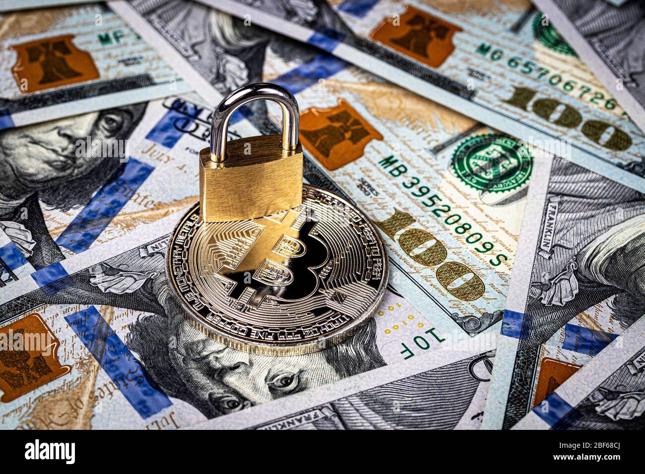 Dollar bills, yellow lock and metal souvenir bitcoin. The concept of  virtual money, online trading, mining and commerce. Electronic wallet  blocking. C Stock Photo - Alamy
