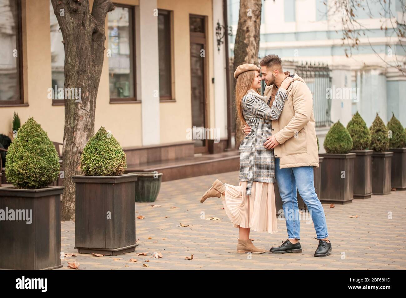 Portrait of happy young couple walking outdoors Stock Photo - Alamy