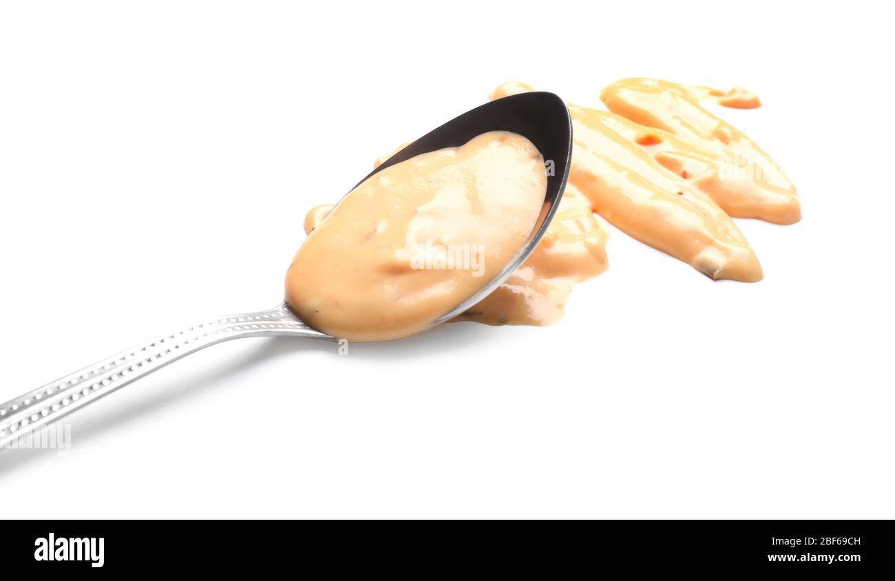 Spoon with tasty sauce on white background Stock Photo