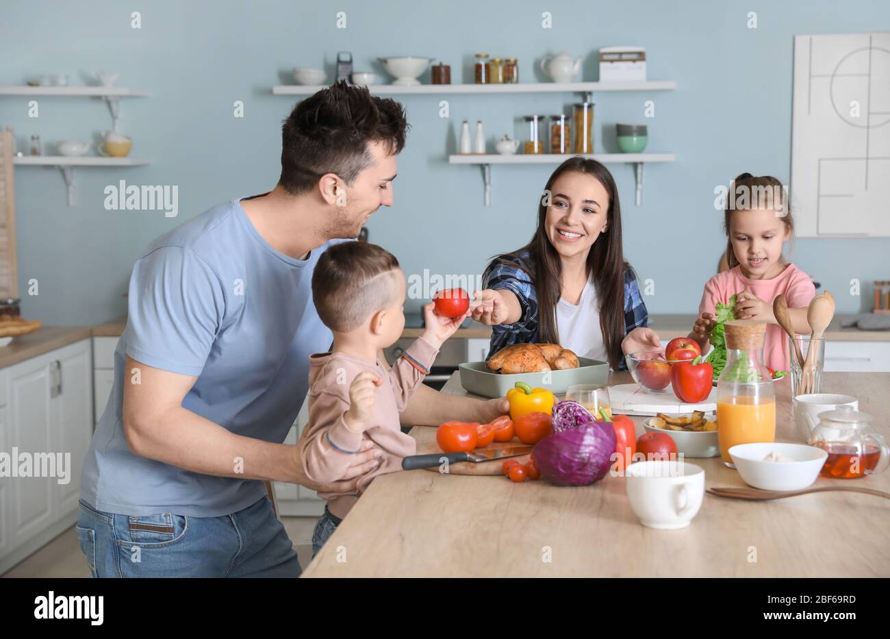 Young Family Cooking Together In Kitchen Stock Photo Alamy