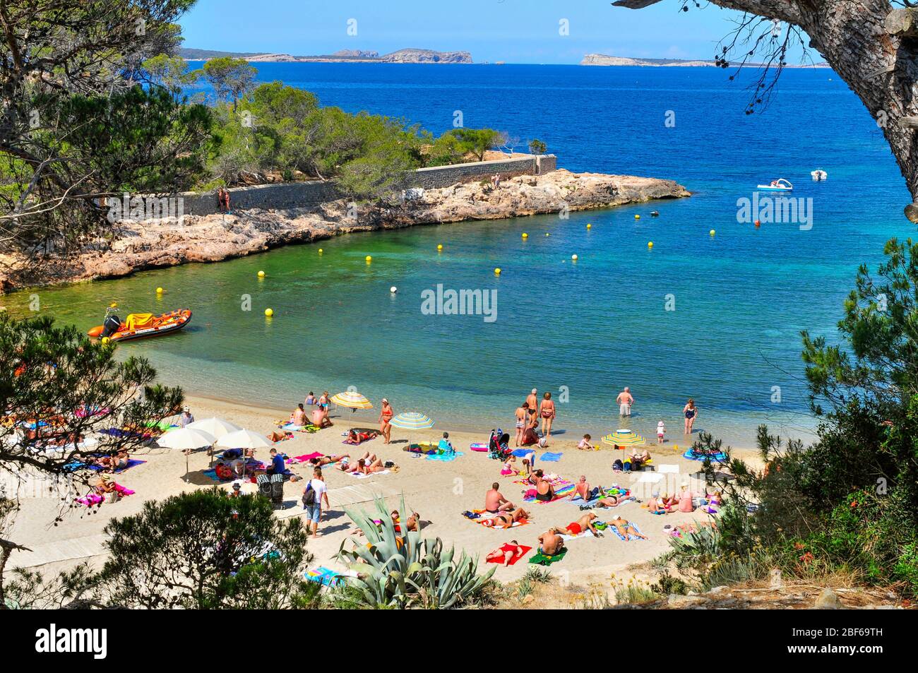SAN ANTONIO, SPAIN - JUNE 18: Sunbathers at Cala Gracio beach on June 18, 2015, in San Antonio, in Ibiza Island, Spain. Ibiza is a well-known summer t Stock Photo