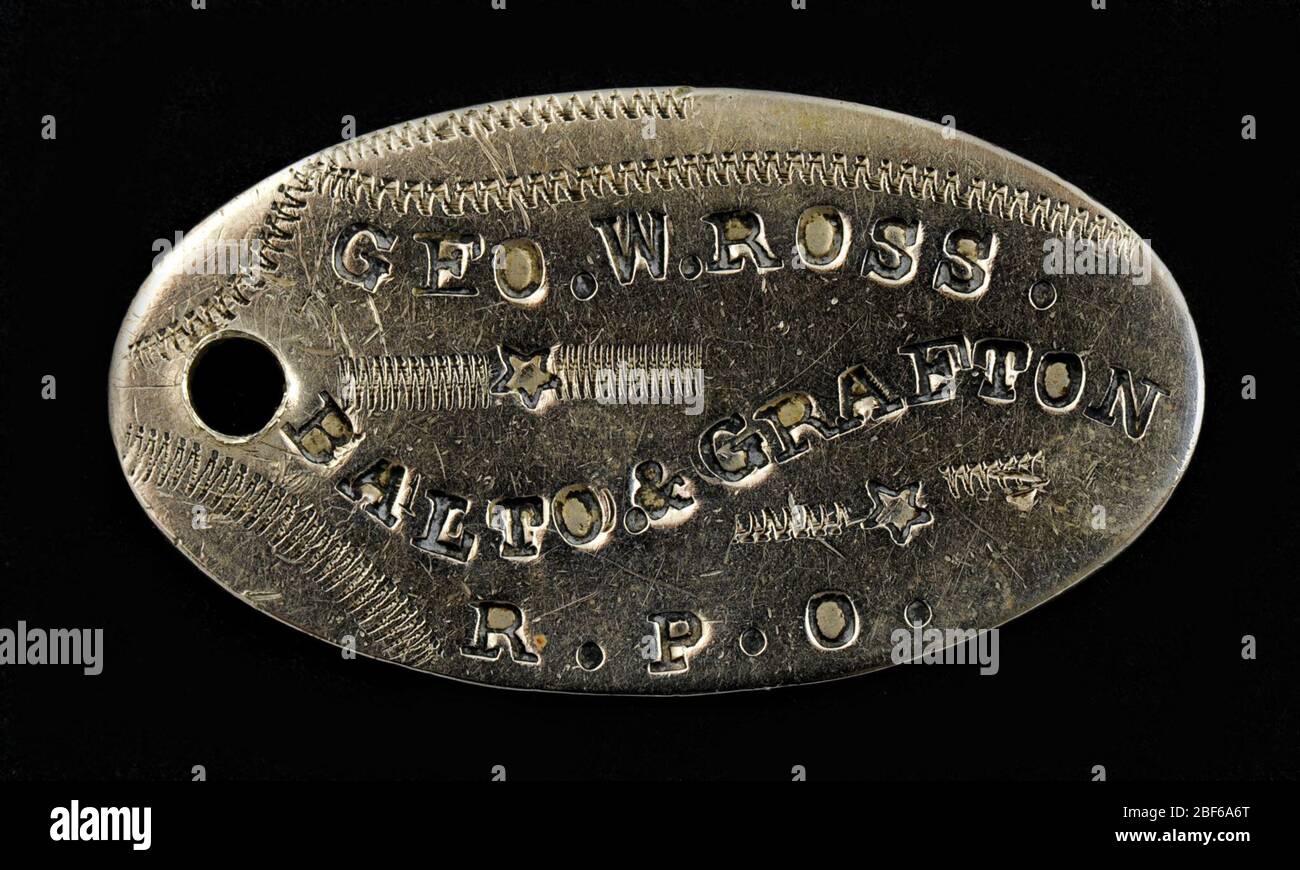 Baltimore and Grafton Railroad Owney tag. The design of this oval-shaped, metal tag is relatively common among the Owney tags. George W. Ross, a Railway Post Office clerk on the Baltimore and Grafton railroad, gave this tag to Owney. There is no available information to indicate when Ross presented Owney with the tag. Stock Photo