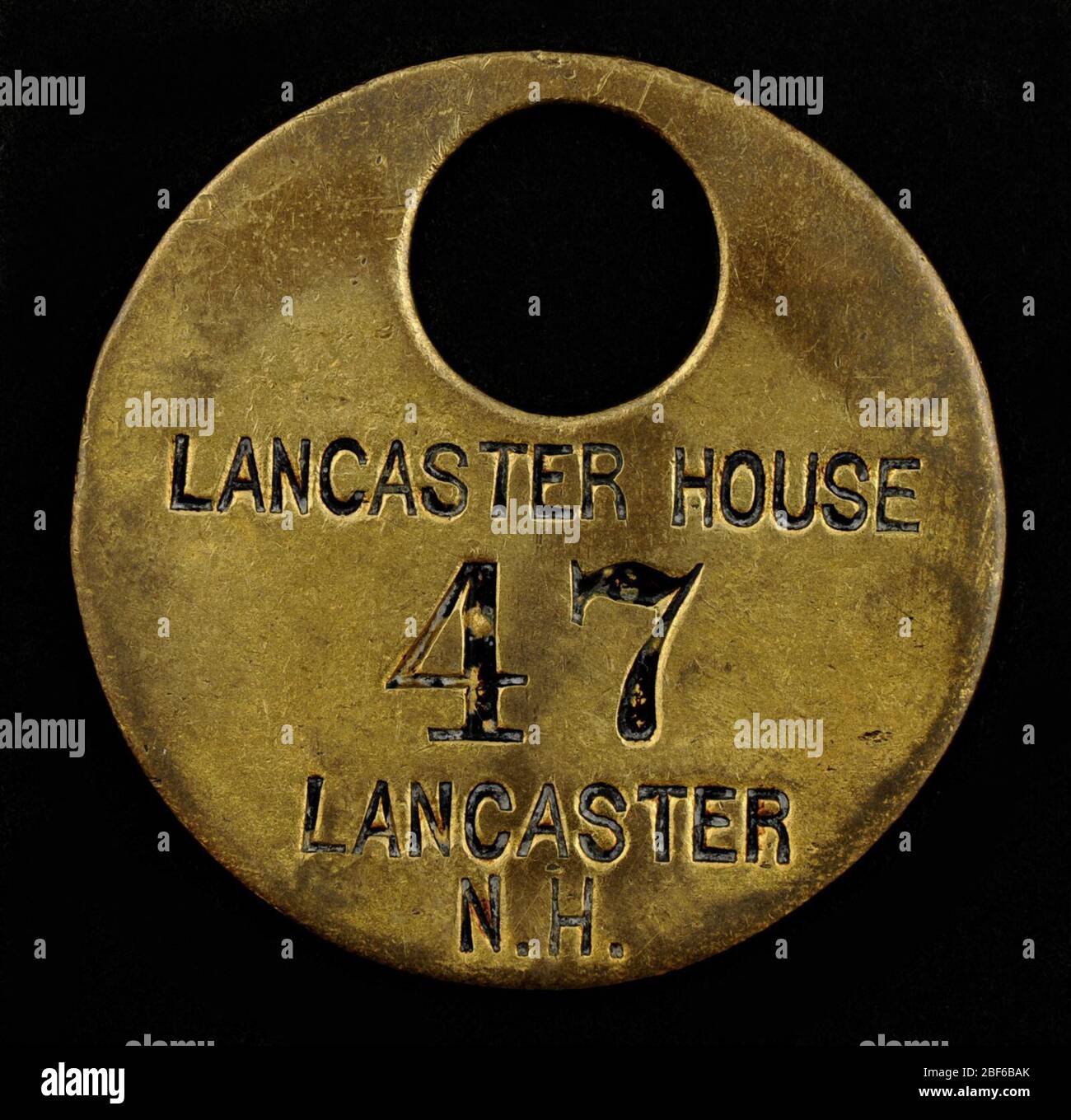Lancaster House Owney tag. Owney received this tag when he visited the Lancaster House in Lancaster, New Hampshire, on May 5, 1896. There is no available information to indicate when this tag was presented to Owney. Stock Photo