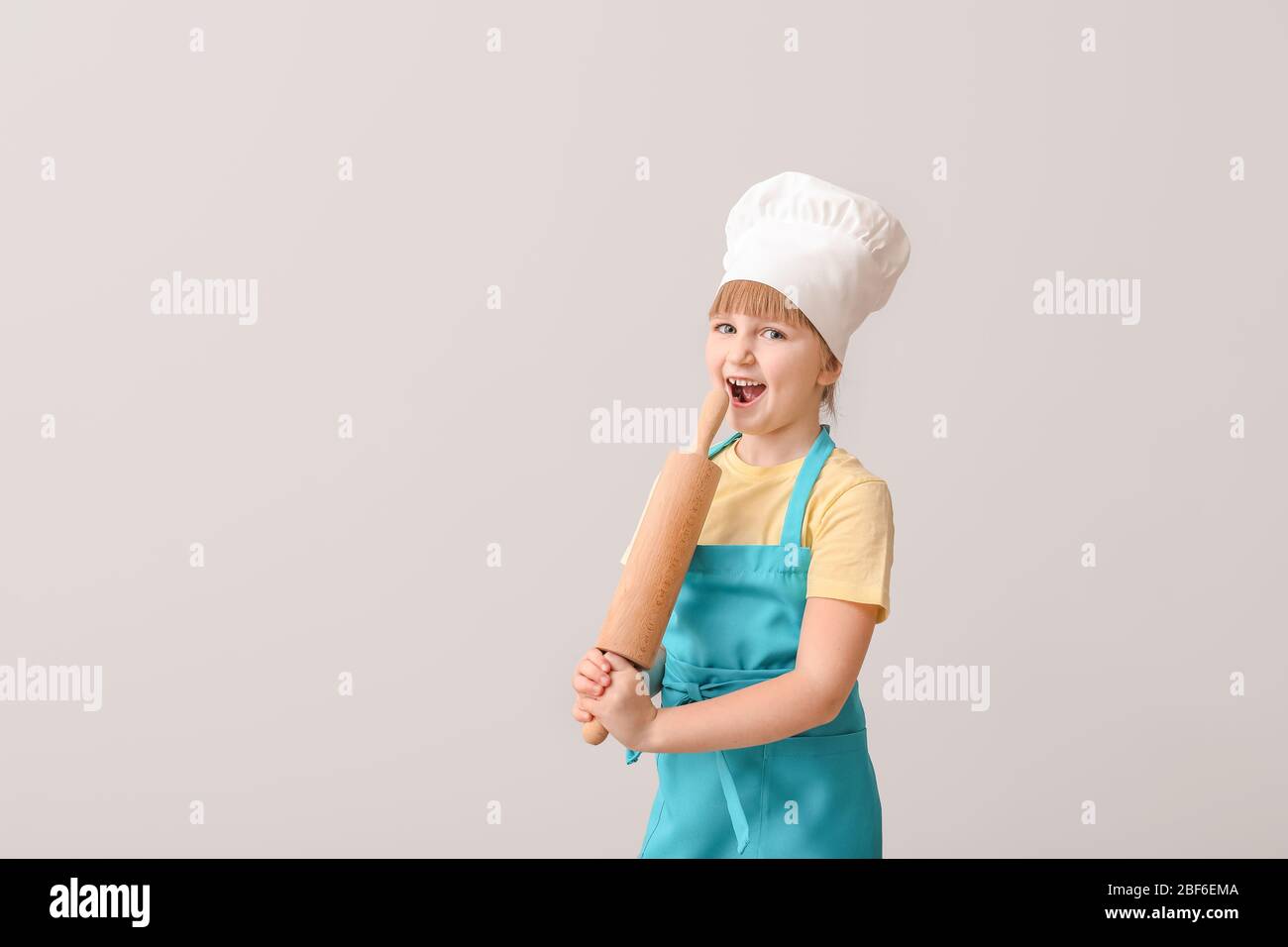 Cute little chef on light background Stock Photo - Alamy