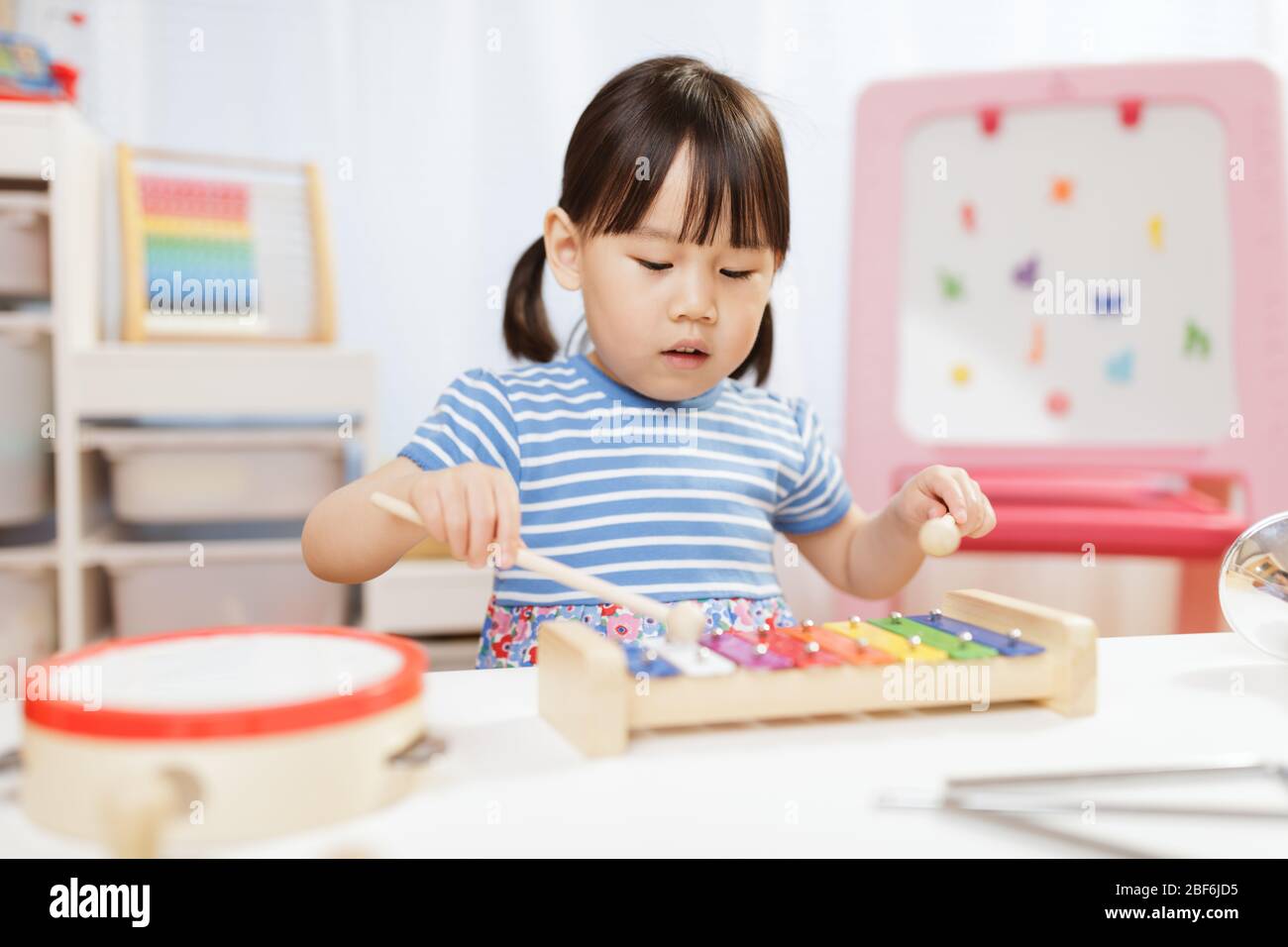 toddler girl play xylophone at home for homeschooling Stock Photo Alamy