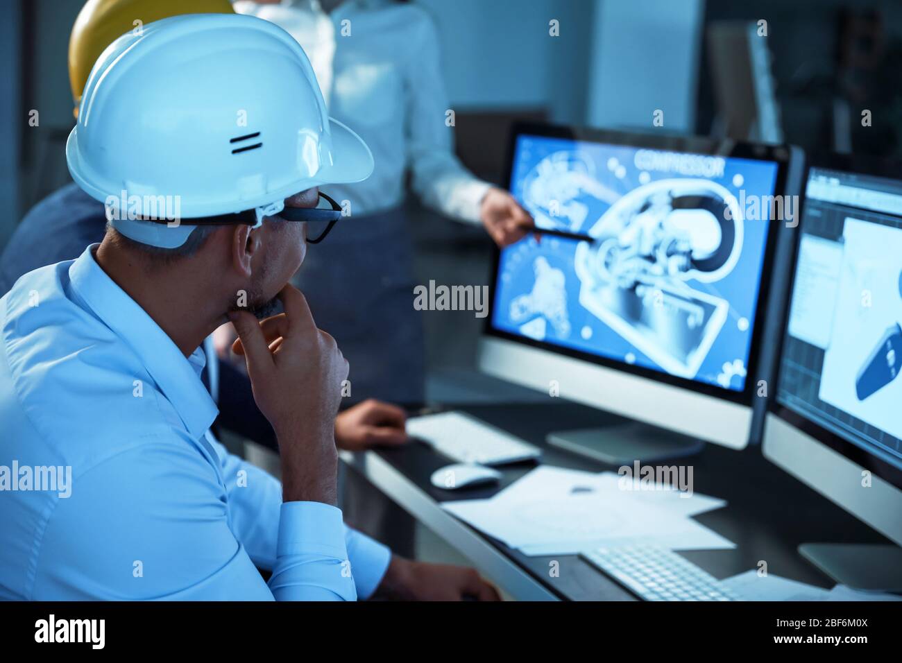 Engineers working in office at night Stock Photo