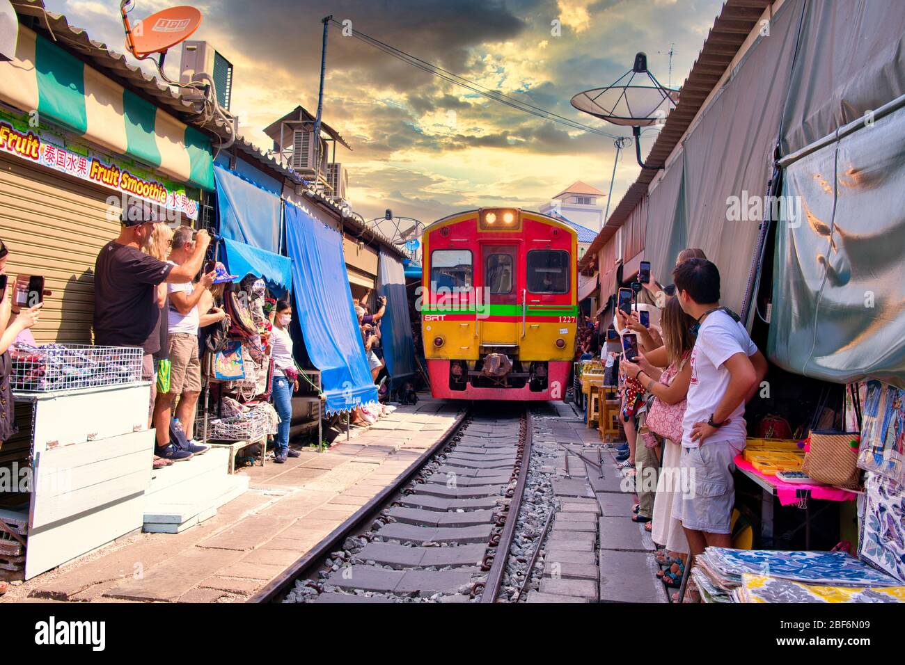 Train passing the Maeklong Train Market - Maeklong Railway Market, located in Samut Songkhram Province in Thailand Stock Photo