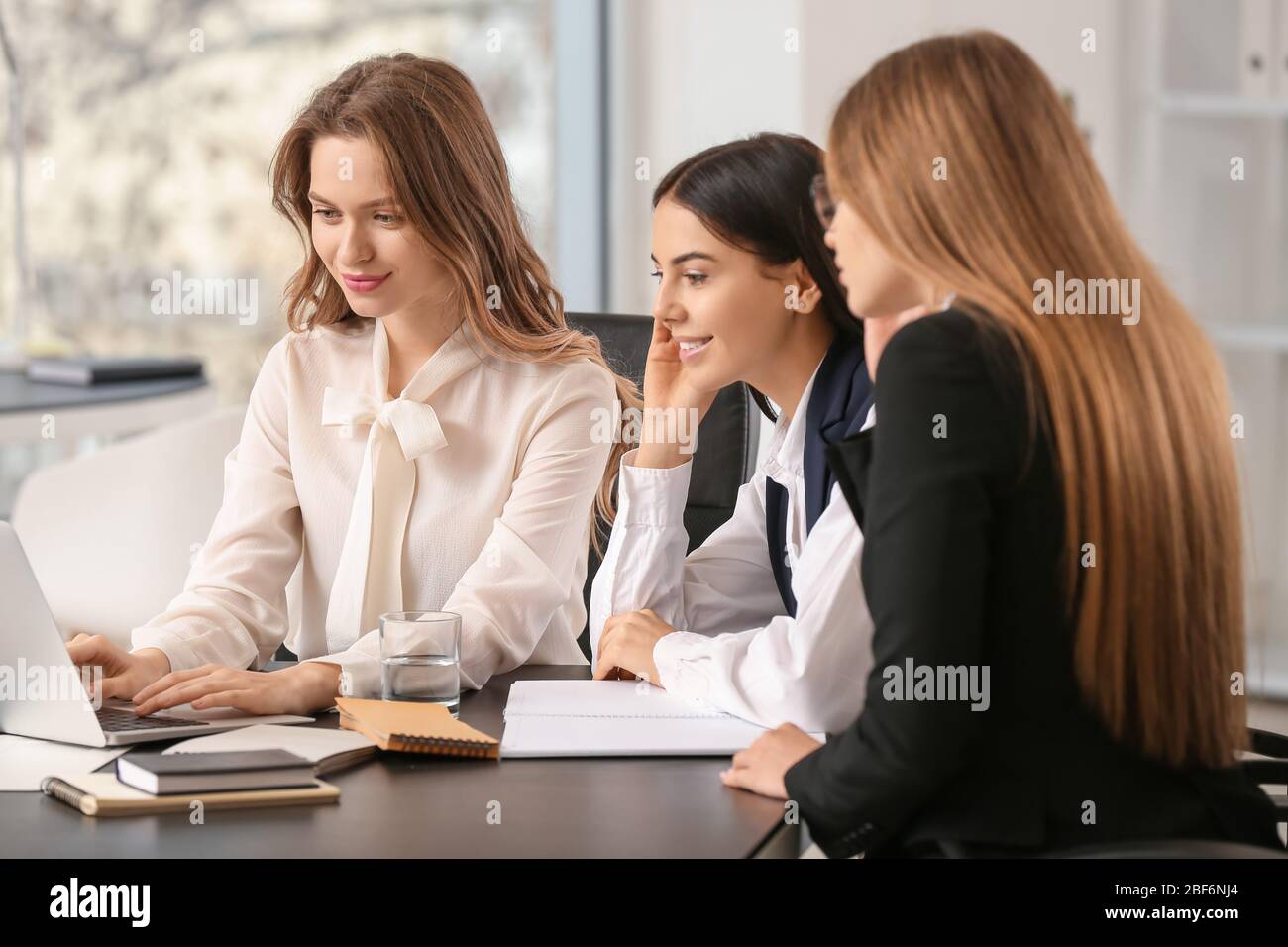 Beautiful young businesswomen working together in office Stock Photo ...