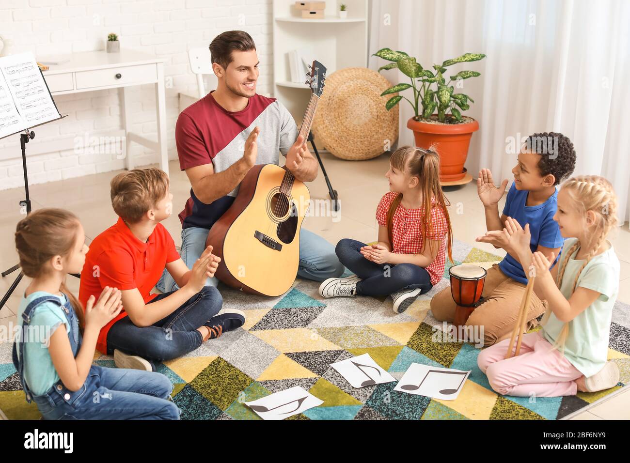 Teacher giving music lessons at school Stock Photo Alamy