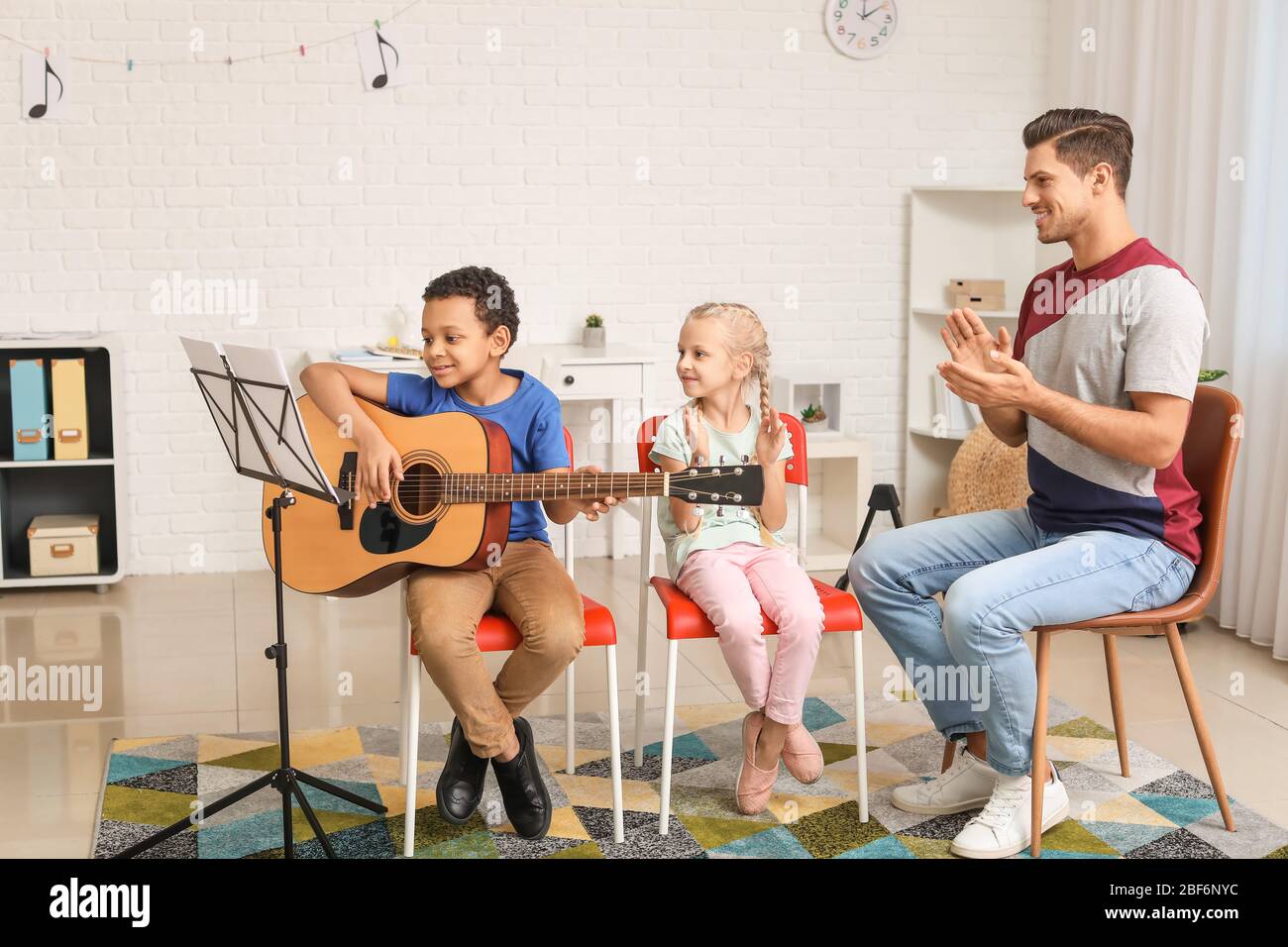 Teacher giving music lessons at school Stock Photo Alamy
