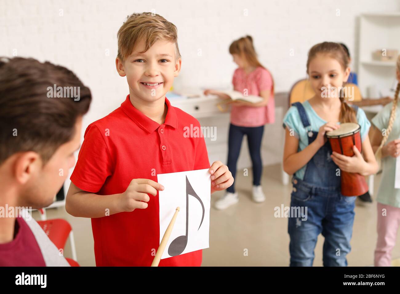 Teacher giving music lessons at school Stock Photo Alamy