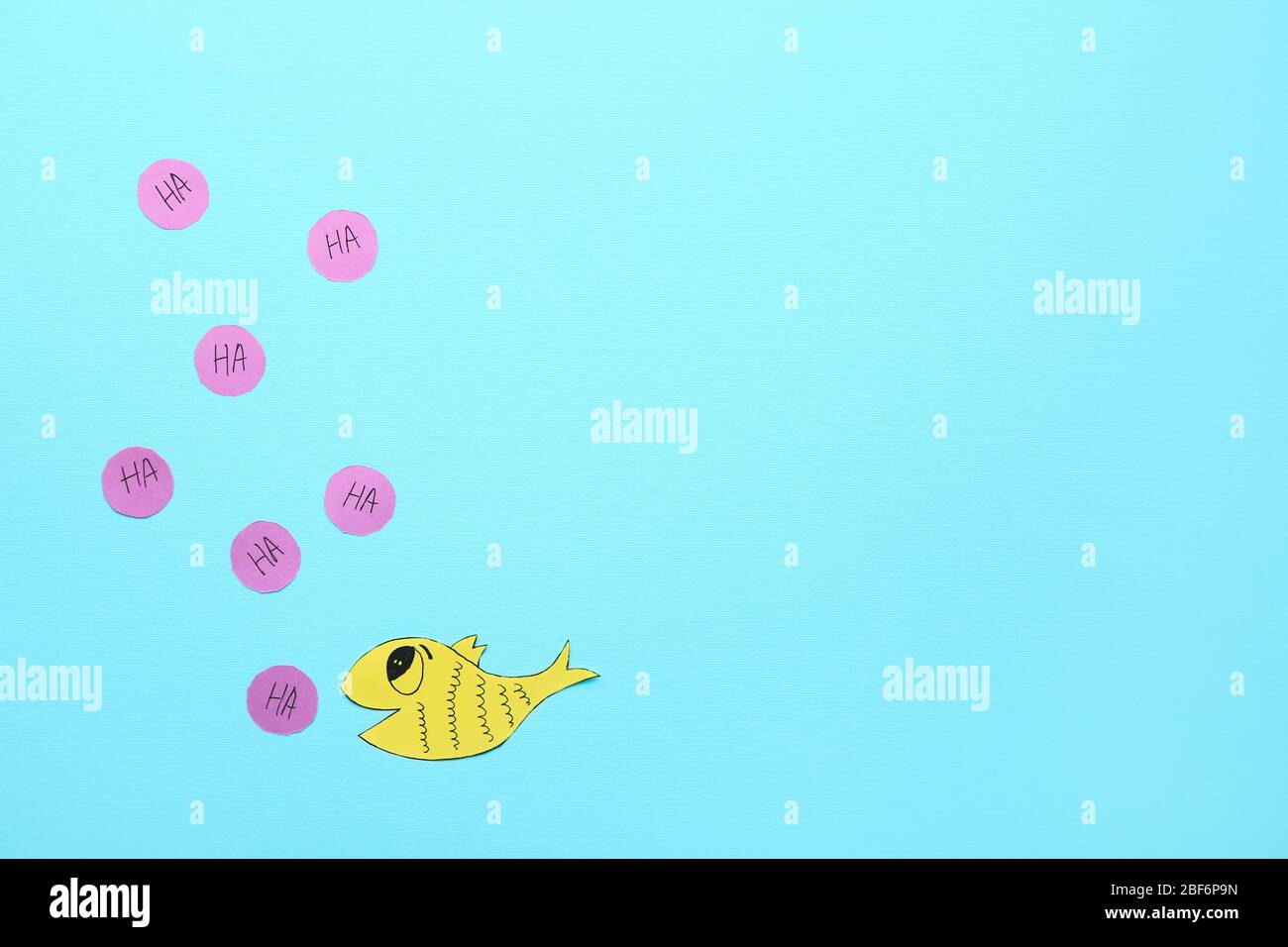 Paper fish on color background. April Fool's Day prank Stock Photo - Alamy