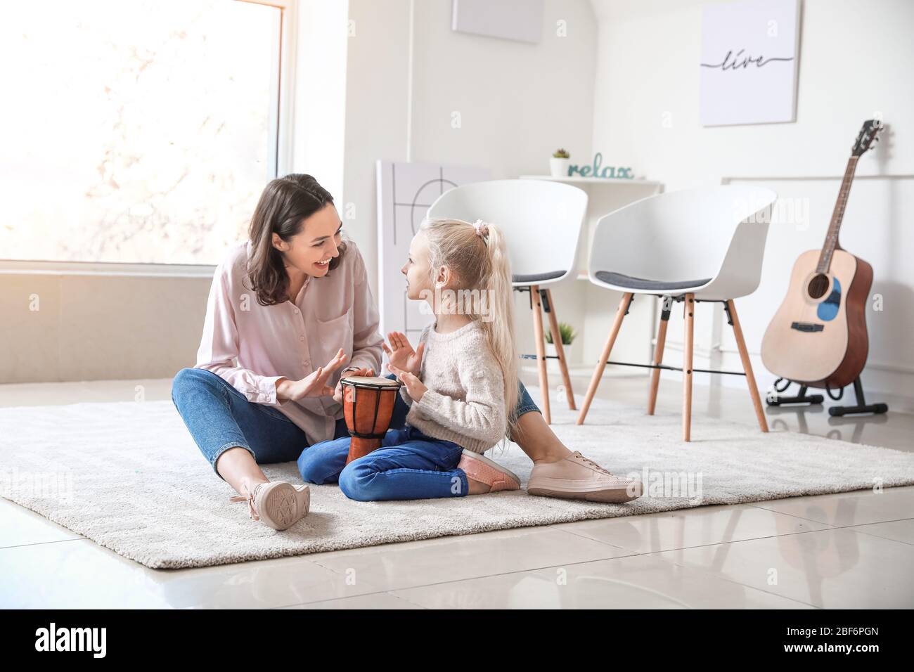 Private music teacher giving lessons to little girl at home Stock Photo ...