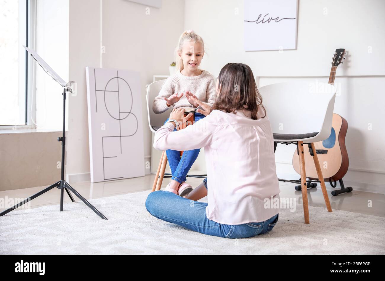 Private music teacher giving lessons to little girl at home Stock Photo ...