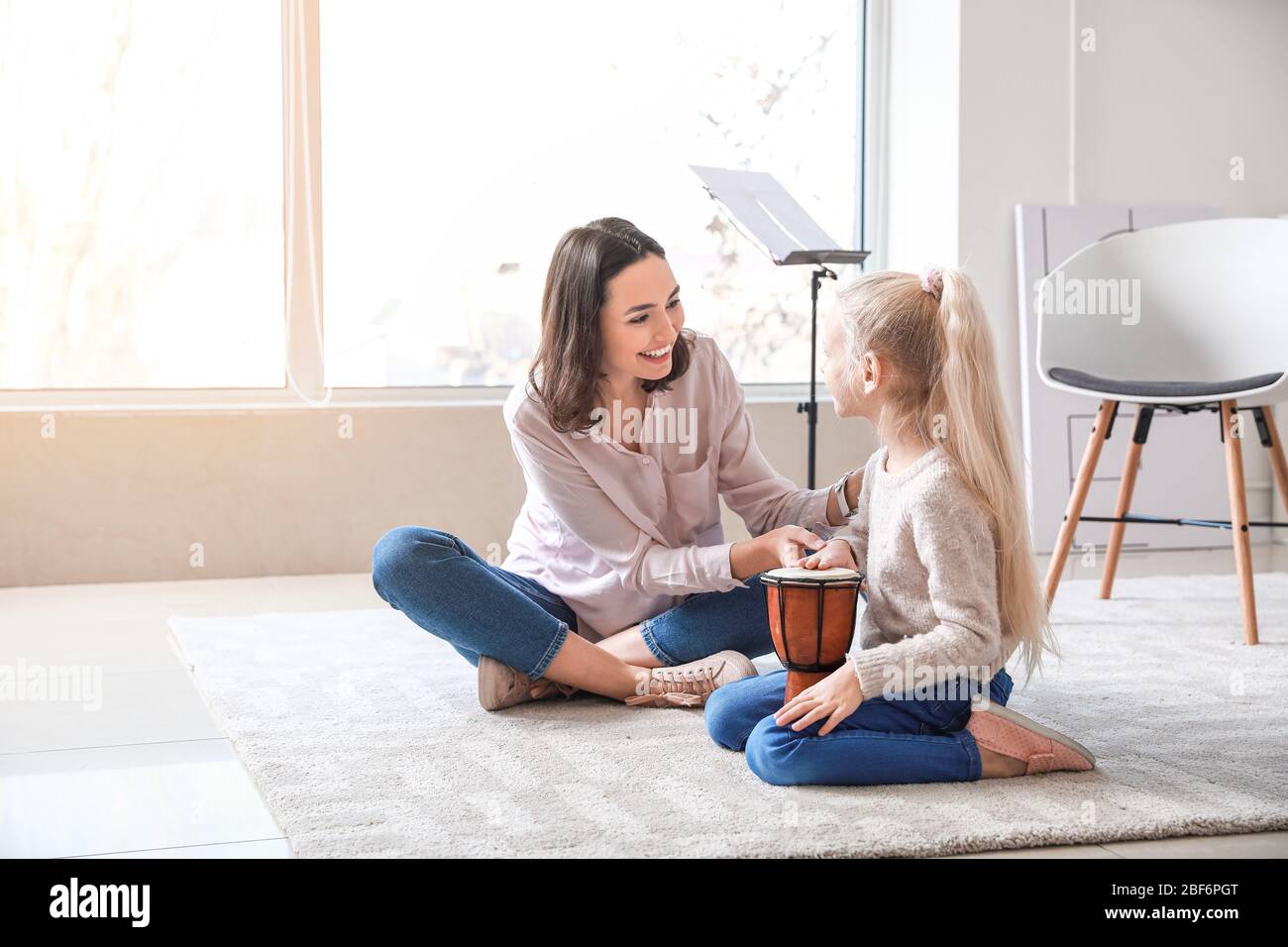 Private music teacher giving lessons to little girl at home Stock Photo ...