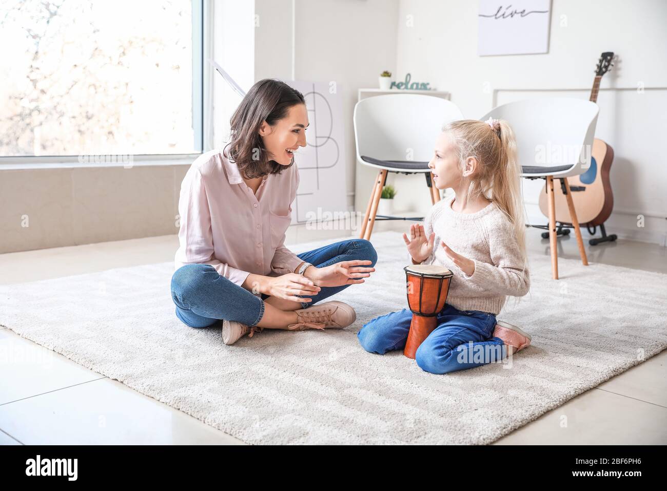 Private music teacher giving lessons to little girl at home Stock Photo ...