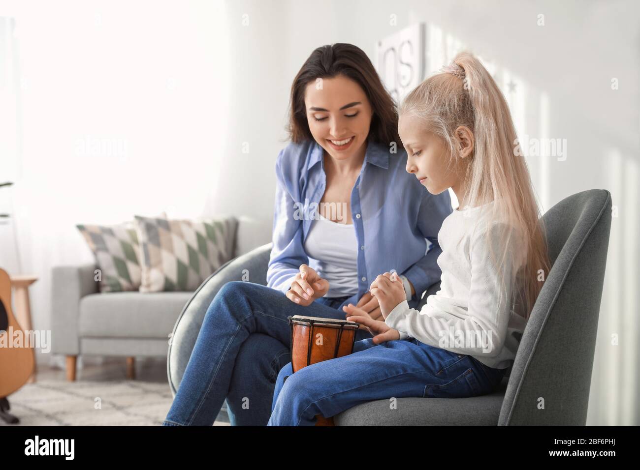 Private music teacher giving lessons to little girl at home Stock Photo ...