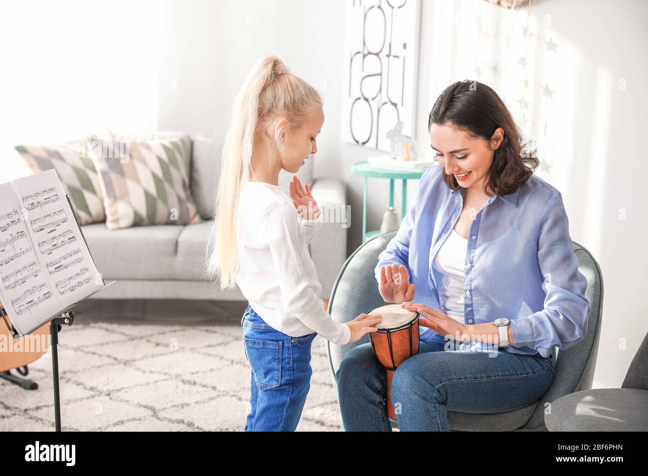 Private music teacher giving lessons to little girl at home Stock Photo ...