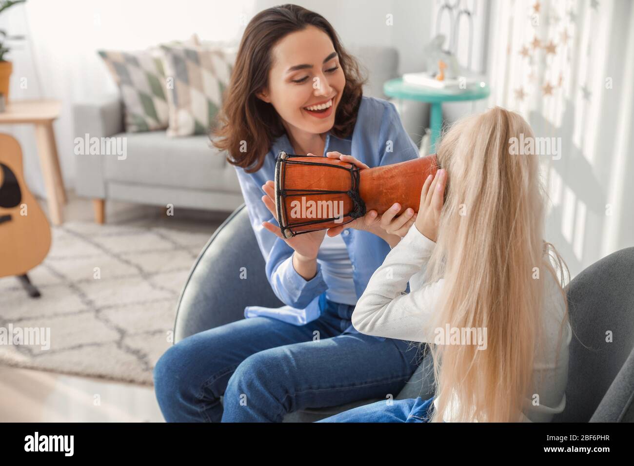 Private music teacher giving lessons to little girl at home Stock Photo ...