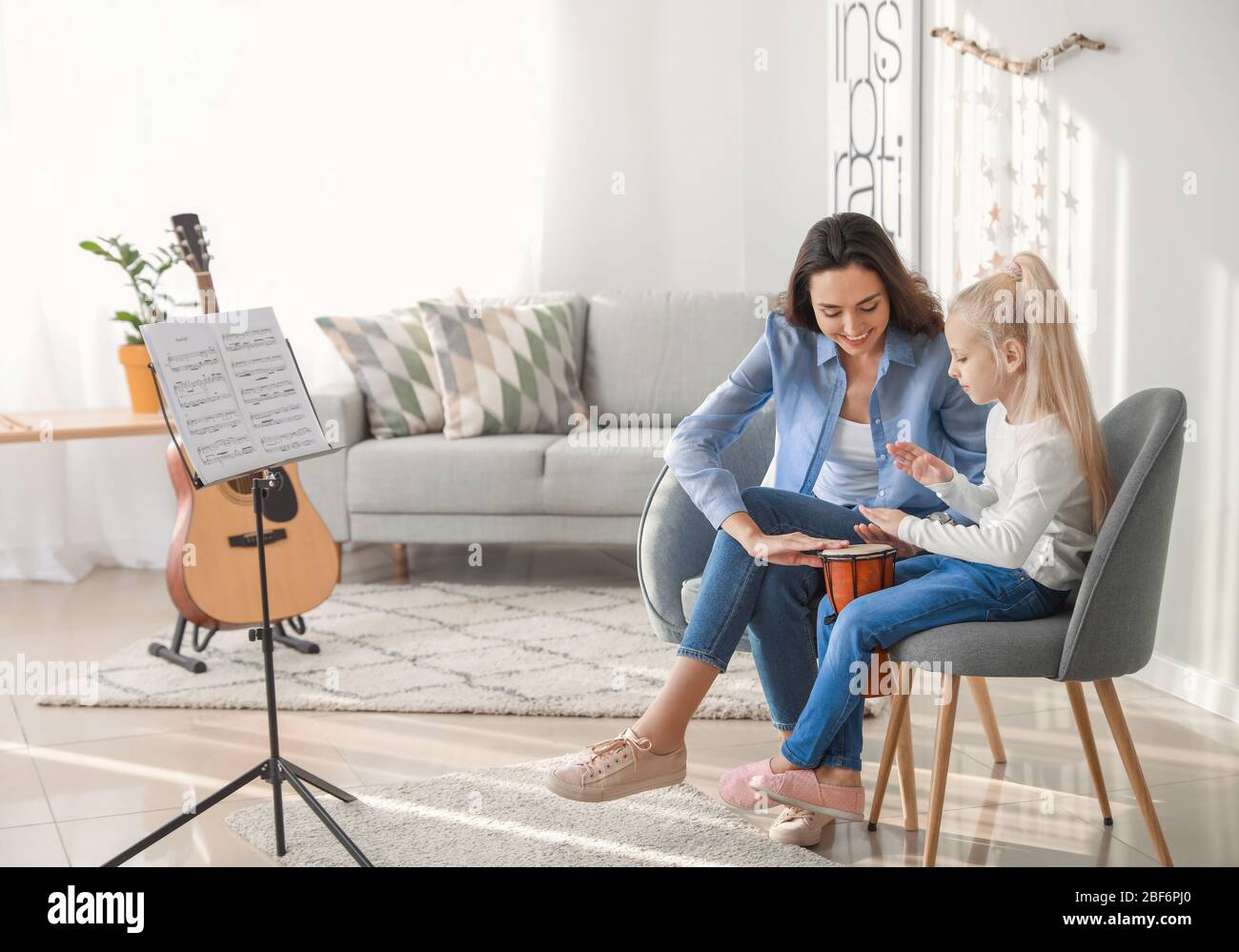 Private music teacher giving lessons to little girl at home Stock Photo ...