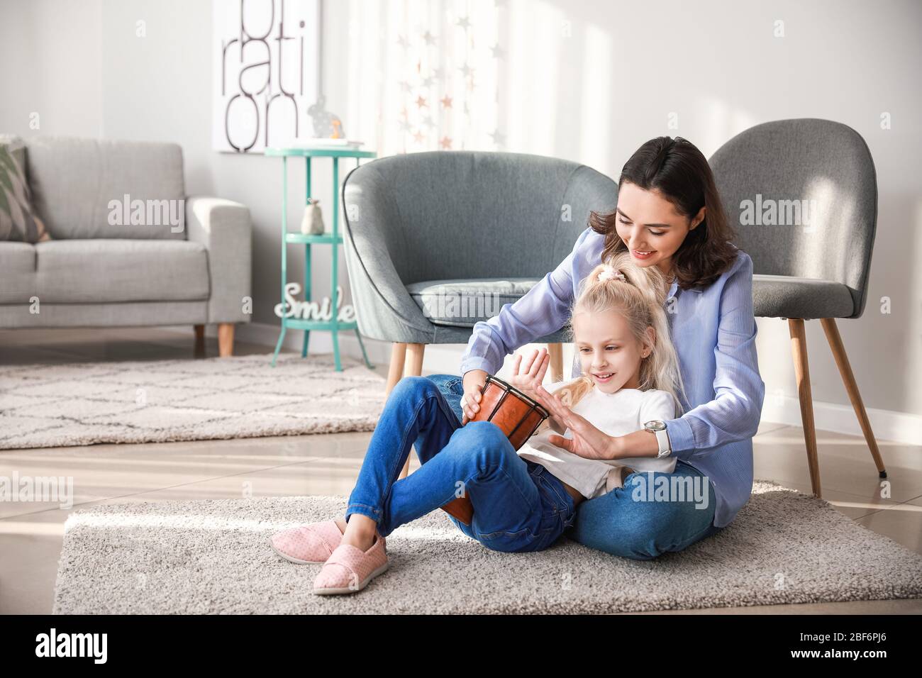 Private music teacher giving lessons to little girl at home Stock Photo ...