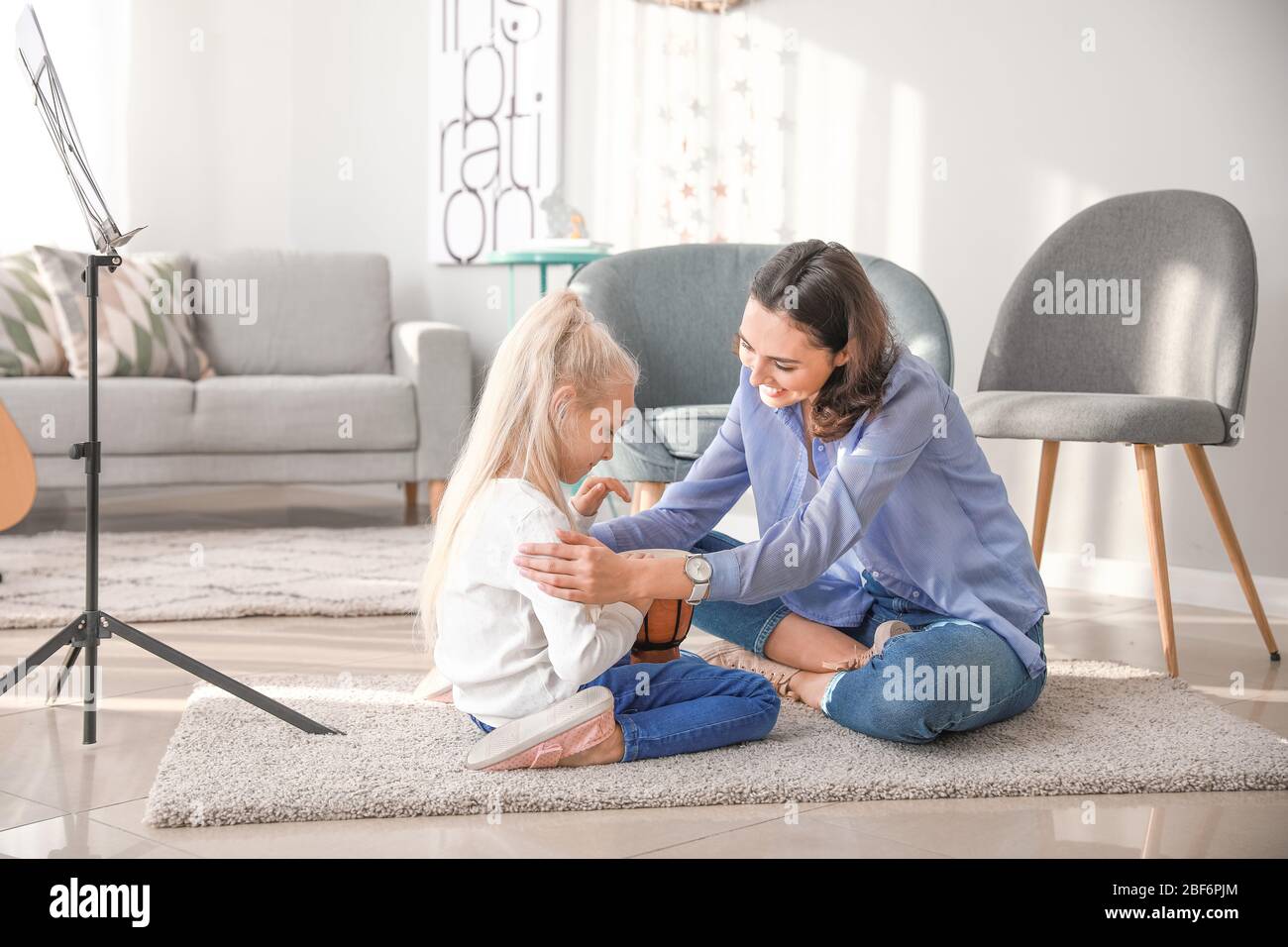 Private music teacher giving lessons to little girl at home Stock Photo ...