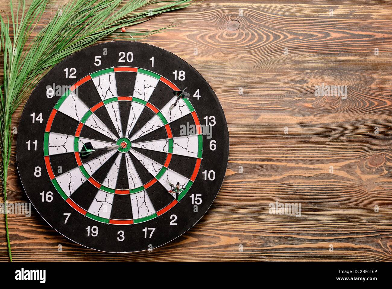 Dartboard hanging on wooden wall Stock Photo Alamy